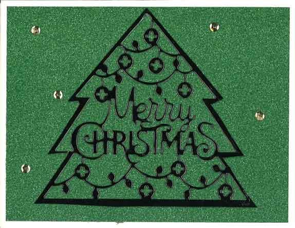 Glitter paper with die cut Merry Christmas tree.